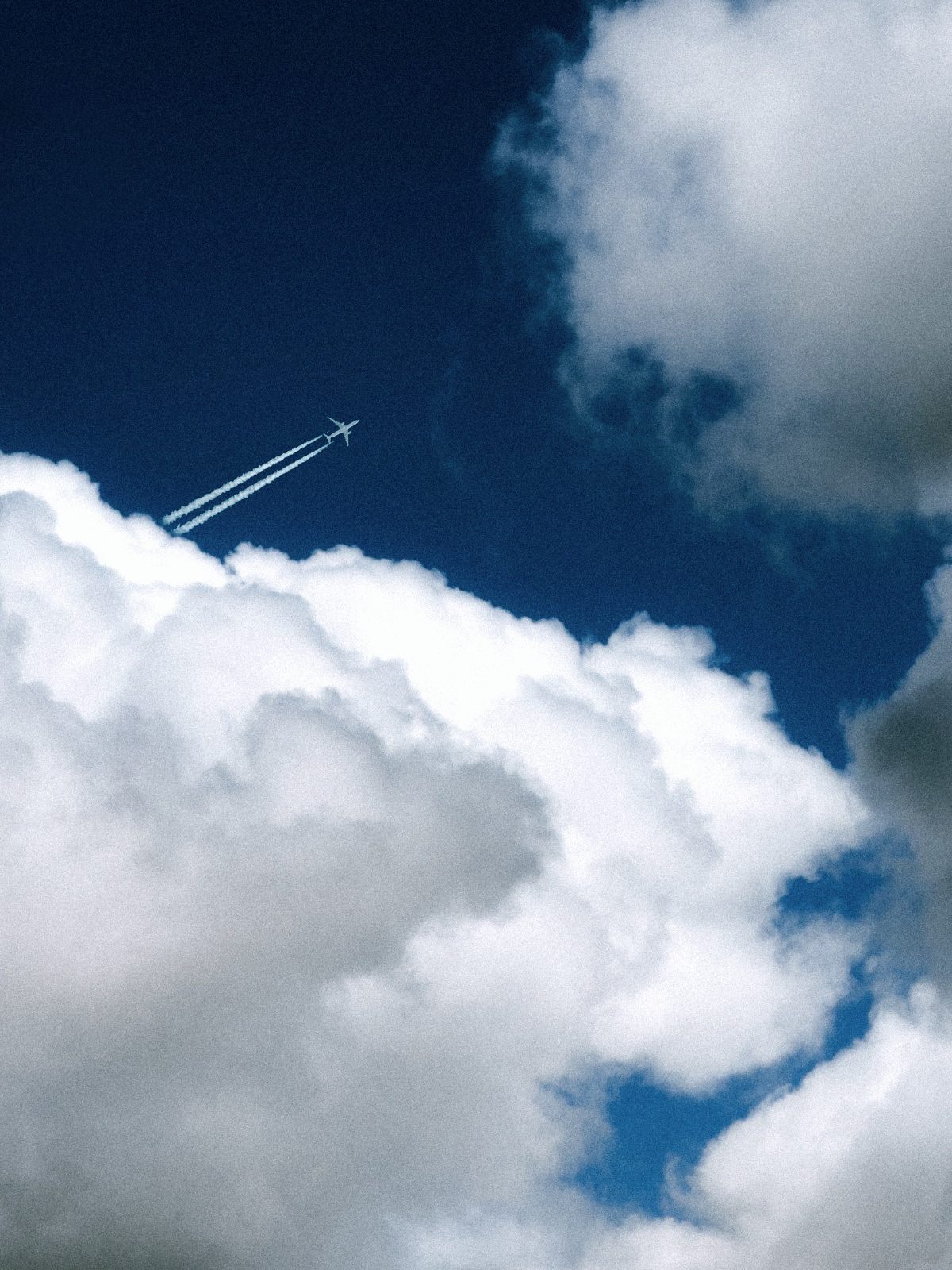 Contrail crossing the clouds