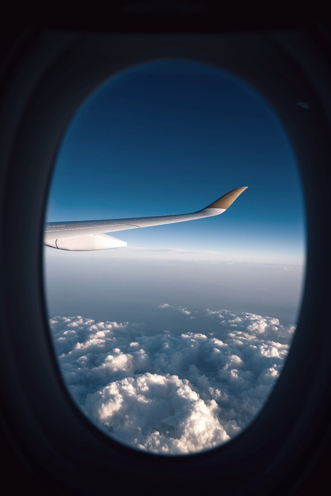 Wing over the clouds at dusk